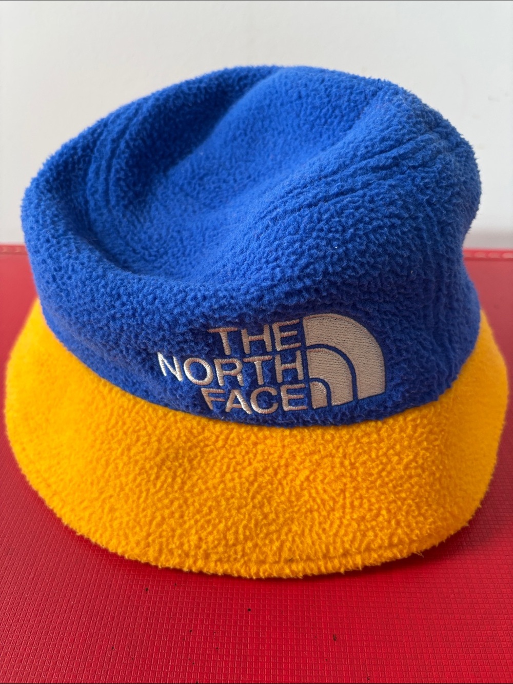 The North Face fleece bucket hat, gold/royal blue, one size